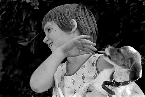 Rhonda Kay Judson, 5, plays with Mrs. Nellie Vess' dog near Trimble 08-13-1968