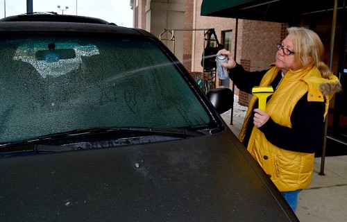 Jan Norris scrapes ice off car in Louisville Ky 01-25-2013