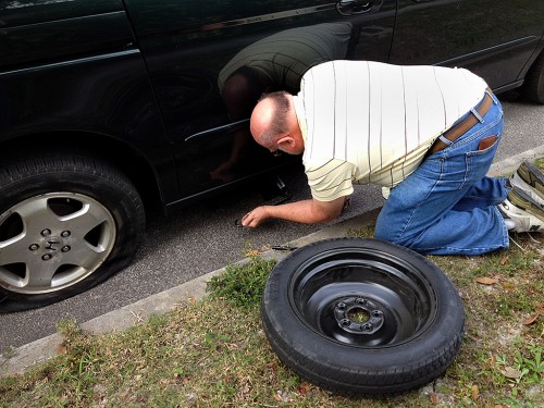 Ken Steinhoff changing tire on Lila Steinhoff's car 01-26-2014