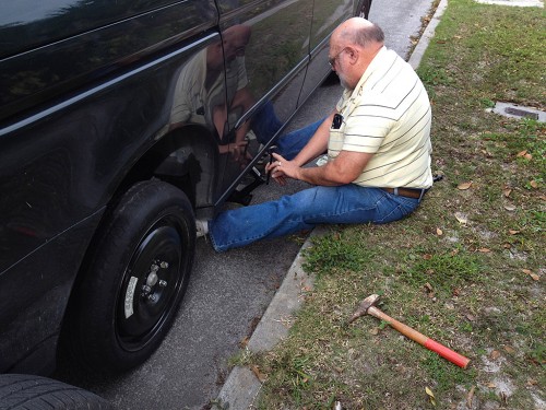 Ken Steinhoff changing tire on Lila Steinhoff's car 01-26-2014
