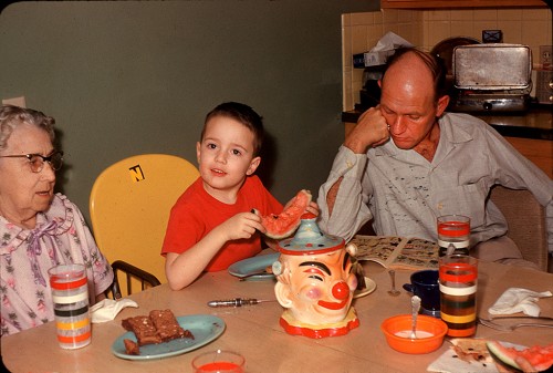 Elsie Adkins Welch, Mark and LV Steinhoff eating winter watermelon at kitchen table March 1961