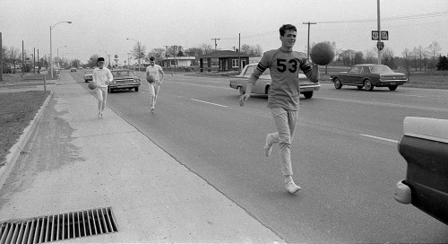 Cape Central High School Student Rick Beck (53) dribbles a ball Kingshighway on the way to Jackson