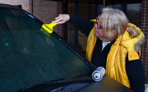 Jan Norris scrapes ice off car in Louisville Ky 01-25-2013