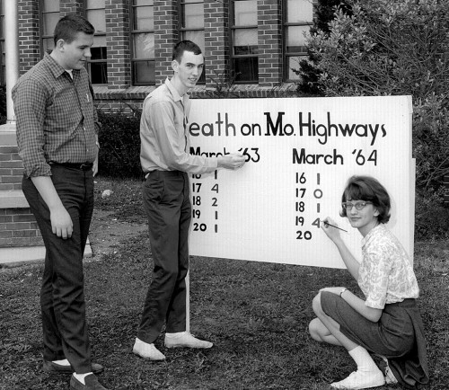 Al Spradling Jr, Ron Marshall, Carolyn Penze with safety billboard in 1963