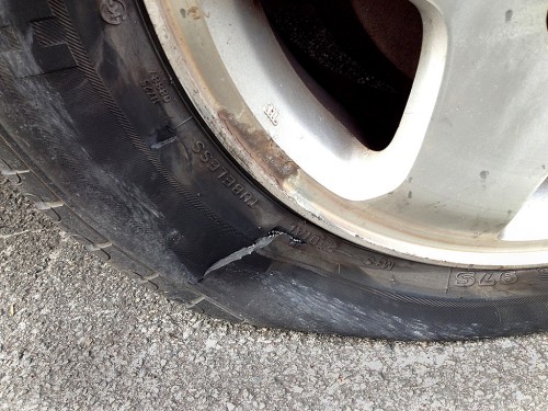 Ken Steinhoff changing tire on Lila Steinhoff's car 01-26-2014