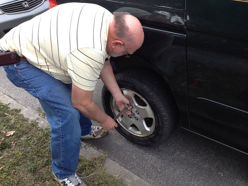 Ken Steinhoff changing tire on Lila Steinhoff's car 01-26-2014