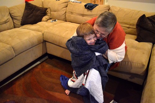 Graham Steinhoff with Lila Steinhoff and the Snowman quilt she made for him